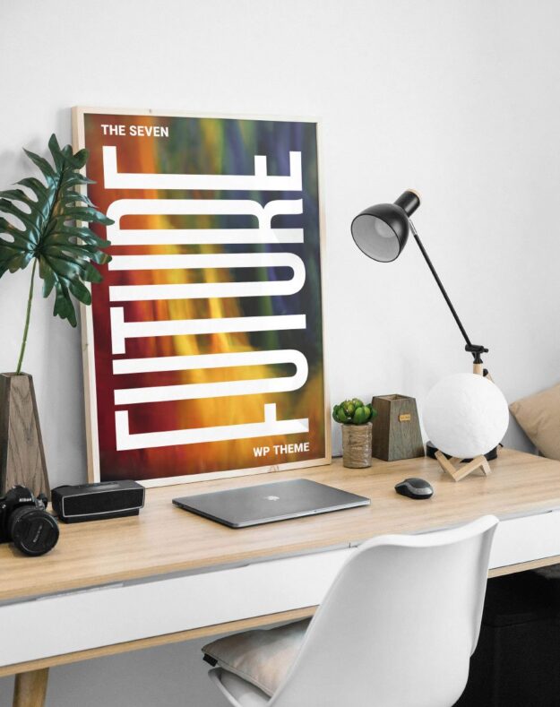A poster on the wall of a room with a laptop and camera.