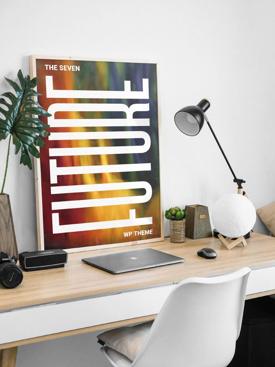 A poster on the wall of a room with a laptop and camera.