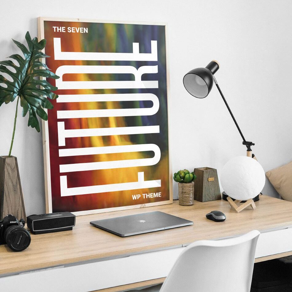 A poster on the wall of a room with a laptop and camera.