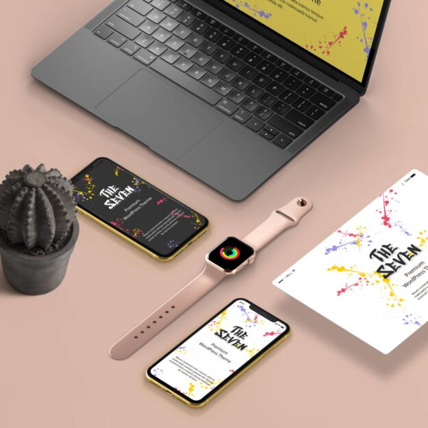 A laptop, cell phone and cactus on the table.