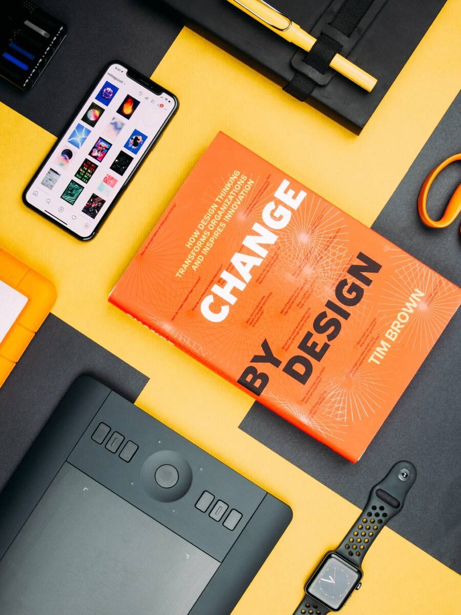 A book is laying on the table next to some other items.
