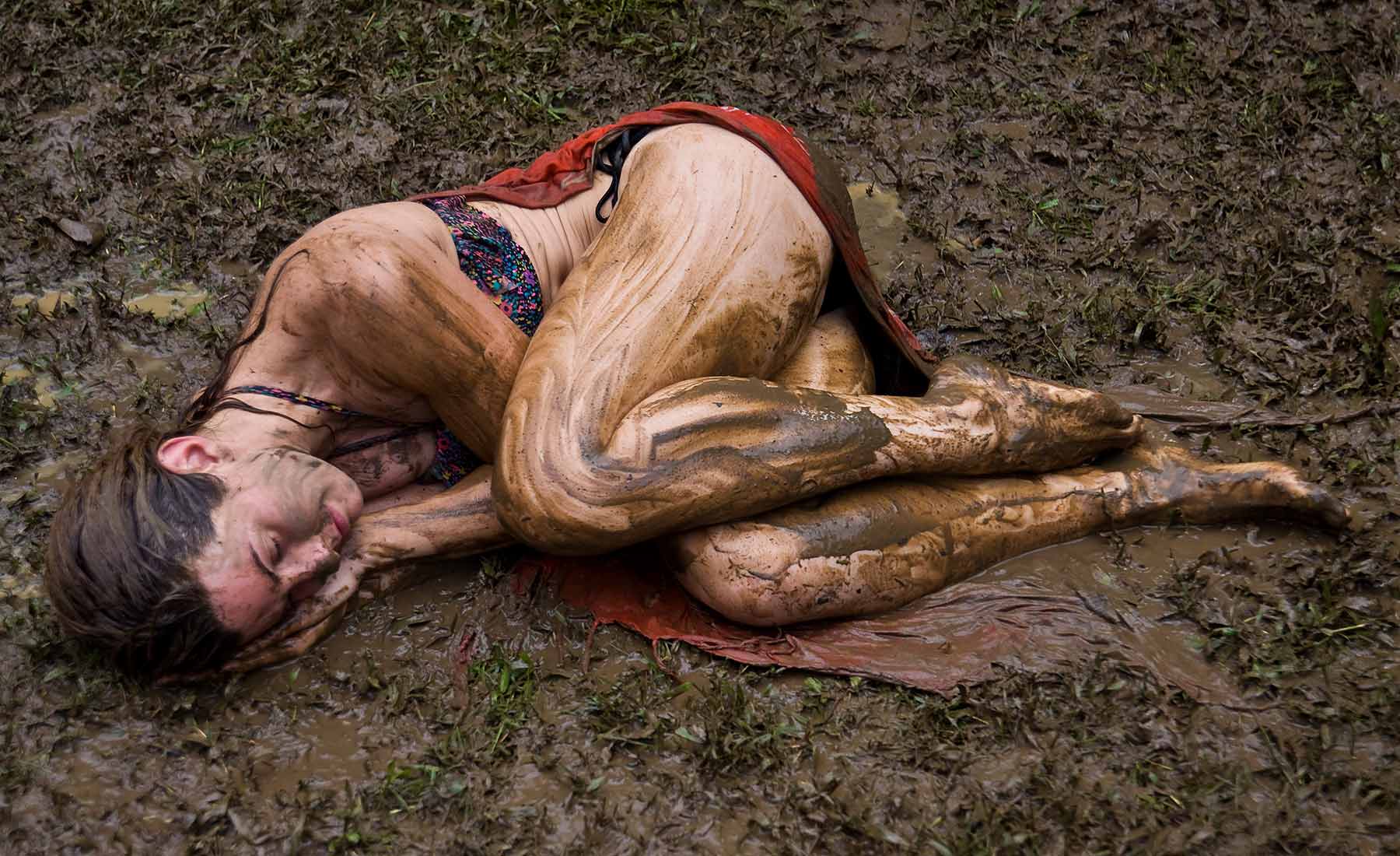 Spiritual Quest - Photo of woman in laying in mud