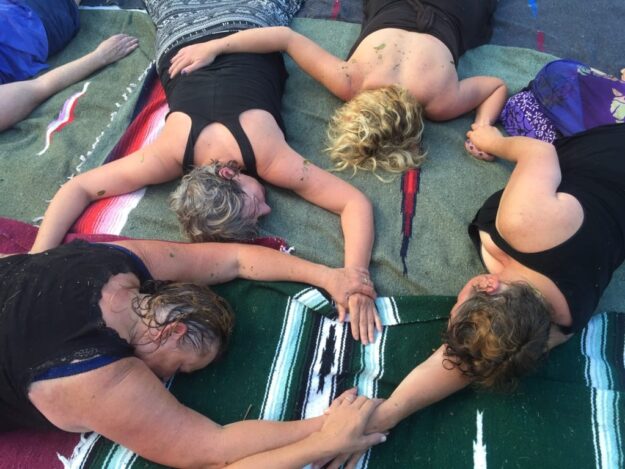 A group of people laying on the ground next to each other.