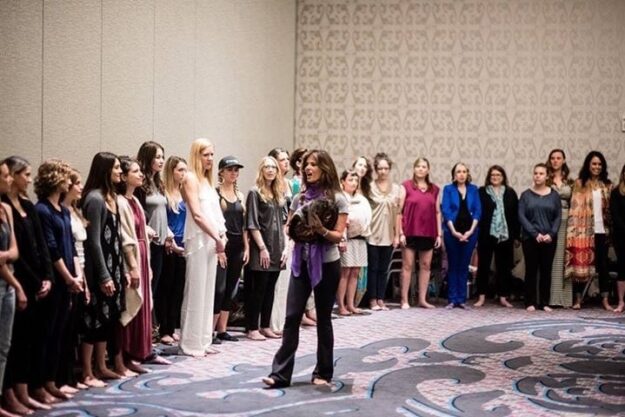 A group of women standing in front of a woman.