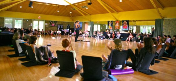 A group of people sitting in chairs on the floor