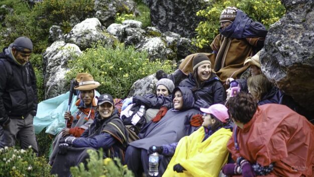 A group of people sitting on the ground.