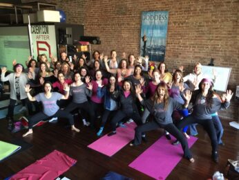 A group of people that are doing yoga