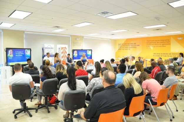 A group of people sitting in front of an audience.
