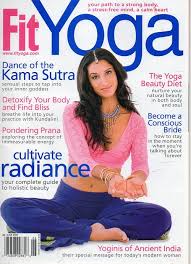 A woman sitting in the middle of a yoga pose.
