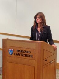 A woman standing at the front of a podium.