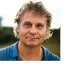 A man with spiky hair and a blue shirt.