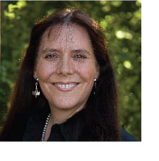 A woman with long hair and wearing earrings.