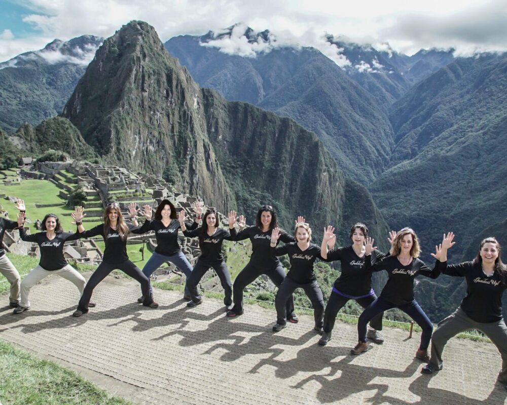 A group of women standing on top of a mountain.