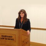 A woman standing at the front of a podium.