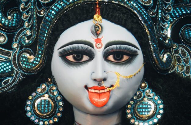 A close up of the face of an indian deity