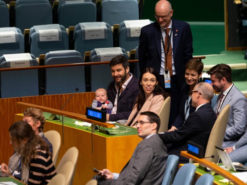 A group of people sitting around in the middle of a room.